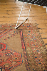 Rectilinear floral patterns and geometric borders on this antique Caucasian rug corner.