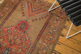 Aged border of an antique Caucasian rug with rectilinear blush and sky blue motifs.