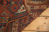 Hand-knotted pile of vintage Kamseh carpet, madder red Herati motif, blue, ivory, worn fringe.