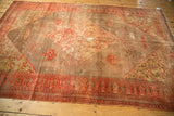 Antique Doroksh rug corner with blush, dusty gold tree of life motifs and faded red border.