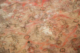 Antique Doroksh carpet's storied wear highlights muted blush and camel tree-of-life motifs.