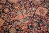 Detailed Herati pattern and visible foundation in madder red and navy blue on antique Malayer rug.