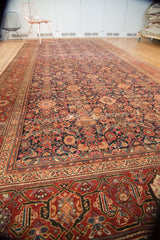 Antique Malayer rug's intricate Herati motif with madder red, navy, and mauve tones.