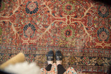 Vintage Mahal carpet with cherry red floral palmettes, navy accents, and visible foundation.