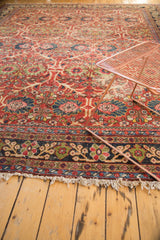 Mahal carpet's navy floral border, allover field pattern, and tattered cream fringe.