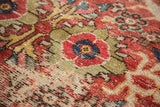 Vintage Mahal rug's cherry red lotus motif, green vinery, and exposed foundation.