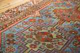 Detail of vintage runner's geometric patterns: sapphire blue, madder red, celadon green.