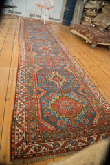 Hand knotted Qashqai rug fringed end, showcasing serrated leaf borders and sapphire blue hues.