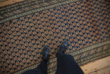 Antique Caucasian runner's navy field, intricate boteh motifs, and powder blue abrashed border.