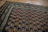 Corner of antique Caucasian runner with allover terracotta boteh motif and powder blue stylized border.