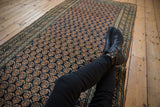 Navy antique Caucasian runner featuring intricate germinating boteh motifs and abrashed border.