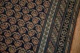 Antique Caucasian runner detail: intricate boteh motifs on deep blue field, with abrashed pale blue border.