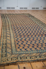 Stylized boteh motifs on the inner border of an antique Caucasian runner, sky blue.