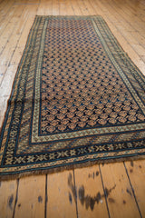 Hand knotted fringe and dark geometric border detail of the antique Caucasian runner.