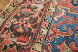 Vivid jewel tone abrash, nuanced salt and pepper floral motifs, and hand-knotted pile on an antique Heriz rug.