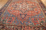 Antique Heriz, vivid blue-green spandrel, brick red field, curled floral motifs, even wear.