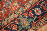 Worn knot heads and time-softened jewel tones in an Antique Heriz carpet border.