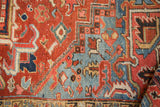 Hand-knotted Heriz pattern detail: brick red, sky blue, and ivory 