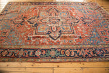 Antique Heriz carpet border detail, showing navy, brick red, sky blue geometric and floral motifs.