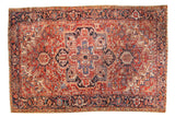 Vintage Heriz carpet, cherry red ground, oversized navy medallion, quatrefoil palmette design, and intricate vinery.