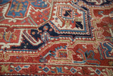 Vintage Heriz carpet's intricate geometric vinery pattern in cherry red, navy, and ivory.