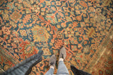Antique Heriz carpet detail, stylized leaves and geometric vinery in indigo, terra cotta, dusty gold.