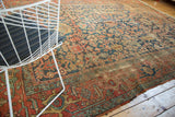 Antique Heriz carpet's allover geometric vinery and stylized leaves in aged indigo and terra cotta.