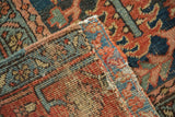 Hand-knotted Persian Heriz carpet folded, revealing pile and foundation in blue and terra cotta.