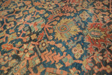 Antique Heriz carpet detail: stylized geometric vinery, indigo, terra cotta, and low pile.