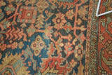 Antique Heriz carpet border and field, stylized vinery in indigo, rust, and seafoam.