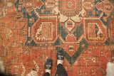 Vintage Heriz carpet detail with bold geometric vinery, palmettes, and faded red, navy, ivory.