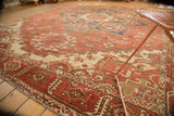 Geometric vinery, palmette finials, madder root red, and ivory tones on vintage Heriz carpet.