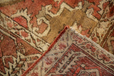 Vintage Heriz rug corner, hand-knotted foundation and textured pile in faded chestnut, madder red.