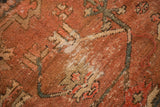 Vintage Heriz rug detail: madder red geometric vinery, worn knot heads, foundation showing.