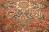 Madder red, faded navy, ivory geometric vinery and serrated leaves on vintage Heriz, showing wear.