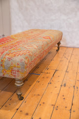 Harmonious pink, yellow, aqua geometric antique Turkish rug fragment with brass caster.