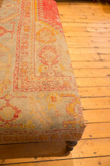 Extra long ottoman corner, antique Turkish rug fragment in harmonious pink, yellow, aqua, and wooden leg.
