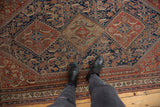 Finely woven antique Qashqai rug with intricate Herati design and time-softened indigo and chestnut colors.