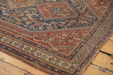 Finely woven hook and latch motifs in indigo blue and chestnut brown on antique Qashqai rug border.