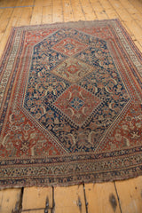 Finely detailed red, blue, and beige border pattern with tattered fringe of an antique Qashqai rug.