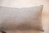 Blue and cream pillow's finely woven fabric with small textured dots.