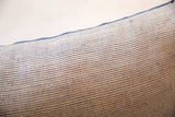 Textured blue and cream fabric detail with repeating square pattern and blue edge.