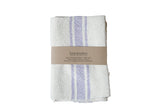 Handwoven cotton napkin set with lavender and cream stripes, folded with a kraft paper band.