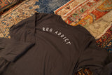 Men's long sleeve t-shirt in gunpowder gray with white arched 'Rug Addict' lettering.