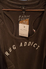 Close-up of the Rug Addict racerback tank top neckline and attached clothing line brand tags.