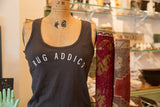 Gunpowder gray Rug Addict tank top on a vintage dress form beside two rolled vintage rugs.