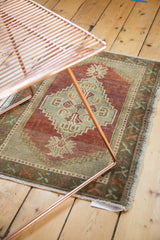 Corner of vintage Oushak rug with stepped contour, palmette, original selvage, and tangerine.