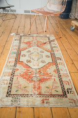 Distressed pile texture with serrated patterns on a vintage Oushak rug.