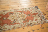 Distressed Oushak runner with dramatic serrated hexagonal medallion, pomegranate red, beige, and visible wear.