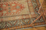 Distressed pile and serrated leaf motif on vintage Oushak runner with terra cotta and beige.